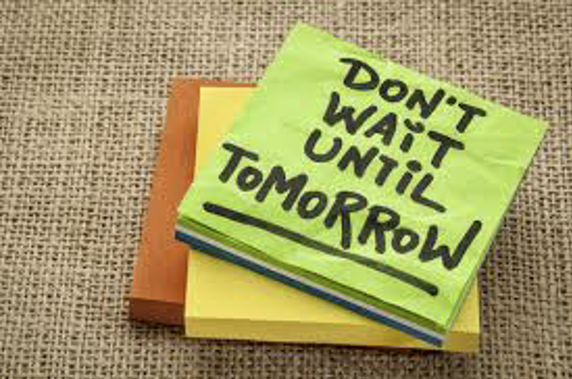 A stack of post-it notes, with the top note reading "Don't wait until tomorrow."